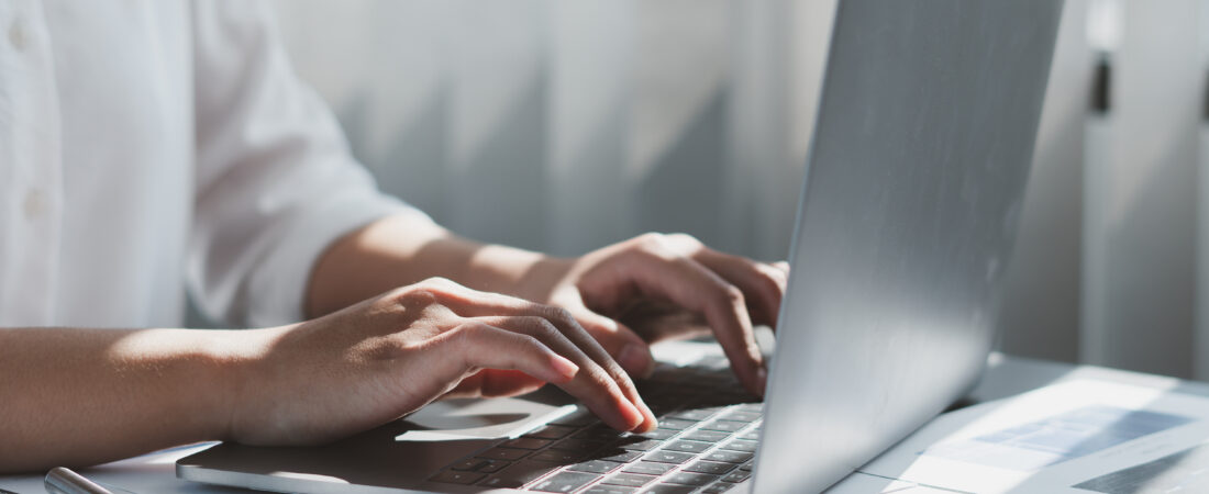 Close up of businessman or accountant working on laptop computer for calculate business data, accounting document and calculator at office, business concept